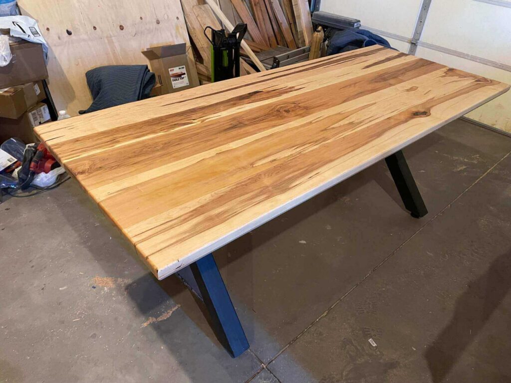 a picture taken while building the brown custom kitchen and a dining table by fox in the the Sawdust