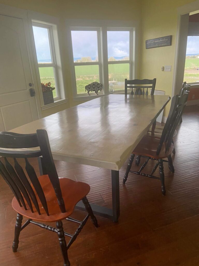 A dining room with the wood dining table and chairs by Fox in the Sawdust